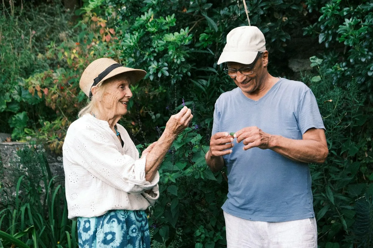 An older couple enjoying a moment together in the garden.