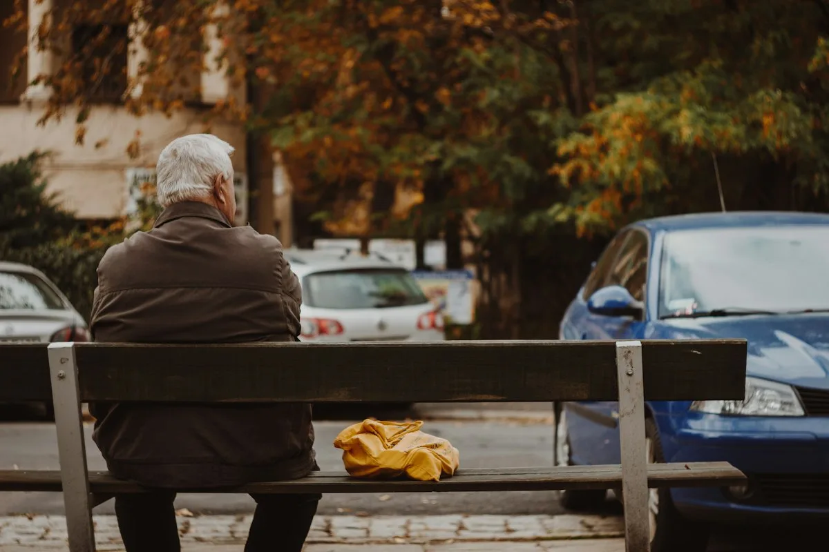 Someone sitting alone on a bench, waiting.