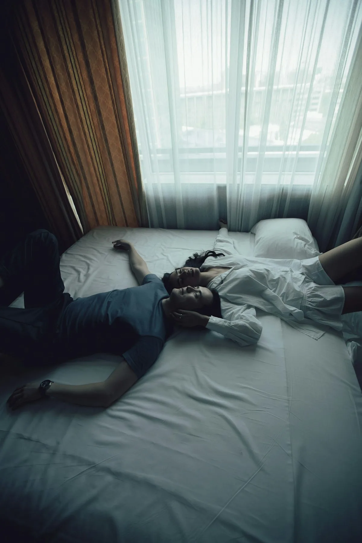 Someone lying alone in bed.