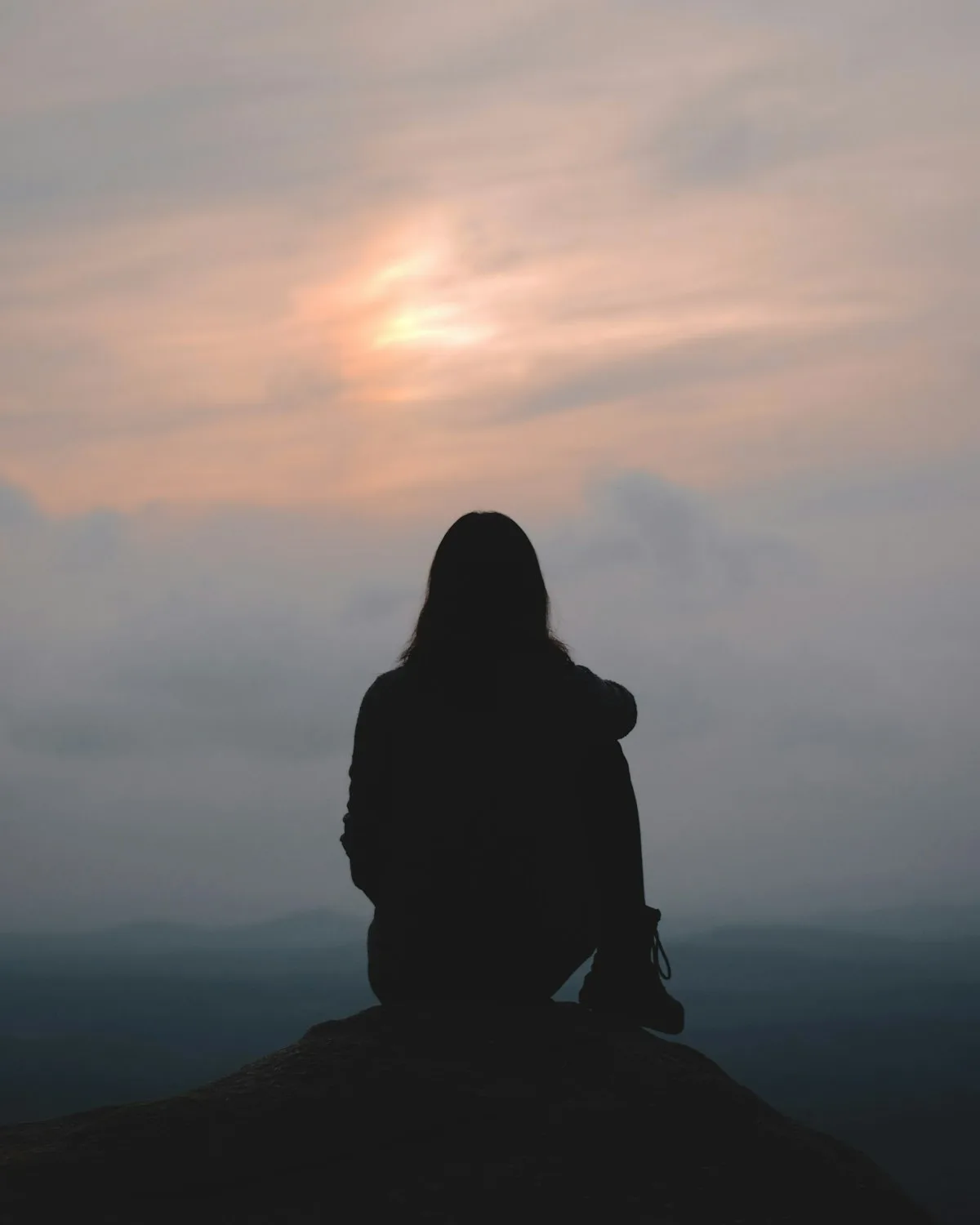 Someone looking up at the sky with hope.