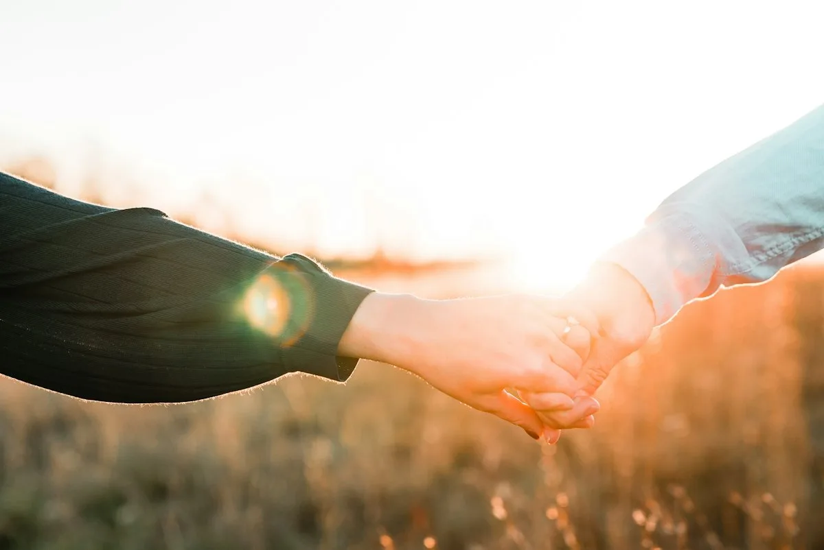 Two people holding each other's hands.