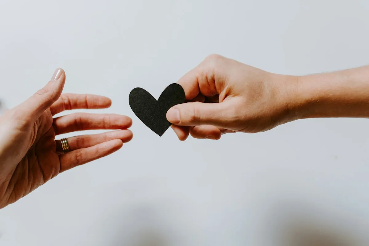 Someone reaching out with a heart.