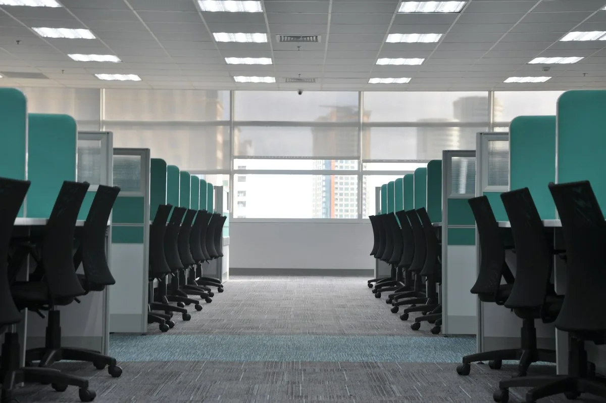 Empty office chairs at workplace cubicles.