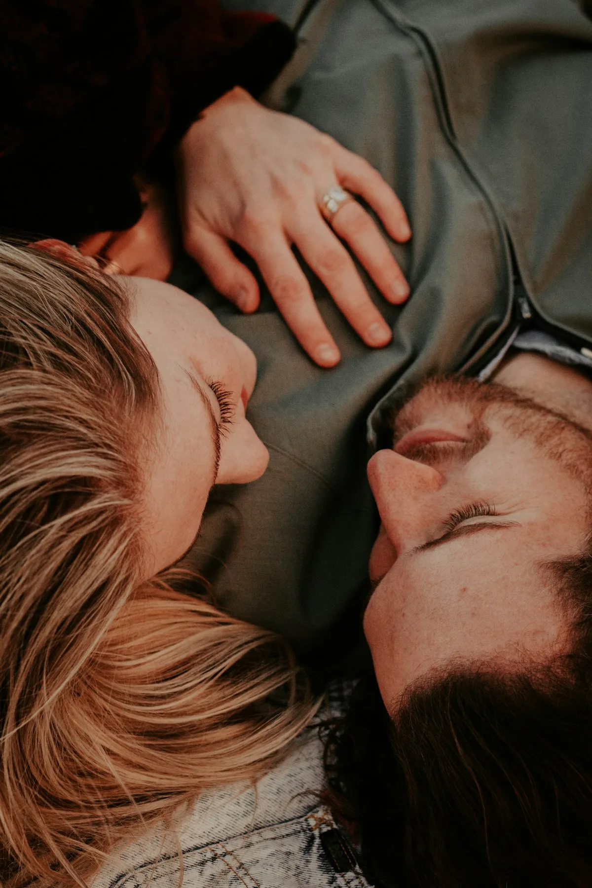 Two people lying head to head.